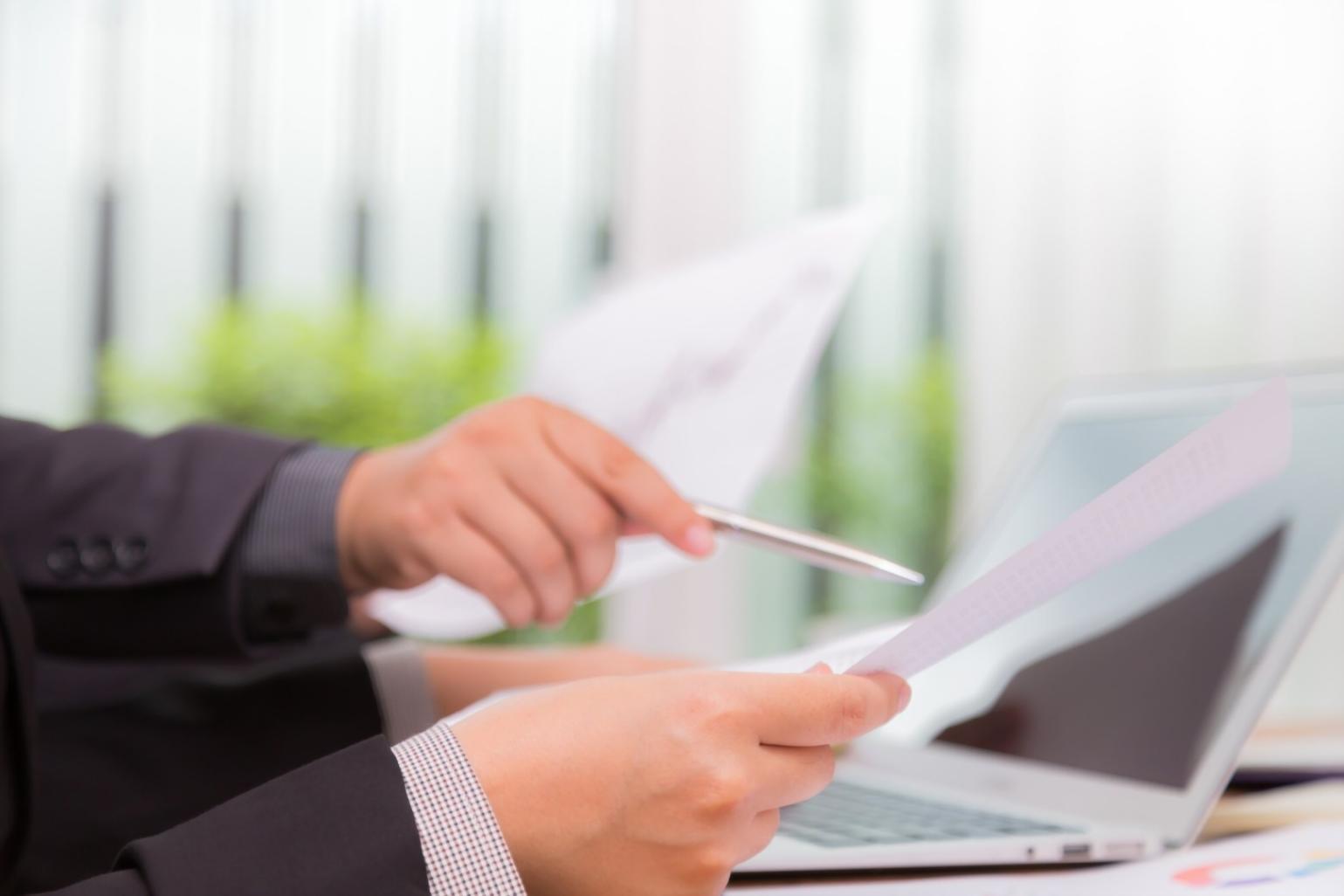 Students collaborating on financial technology projects in modern learning environment